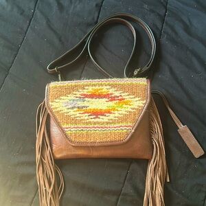 Ariat purse. Brand New with adjustable strap, one inside pocket and frills.
